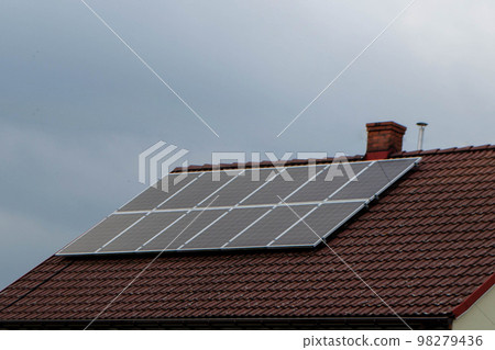 House roof with photovoltaic modules. Historic farm house with modern solar panels on roof and wall High quality photo 98279436