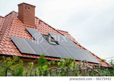 House roof with photovoltaic modules. Historic farm house with modern solar panels on roof and wall High quality photo House roof with photovoltaic modules. Historic farm house with modern solar panels on roof and wall High quality photo 98279442