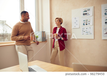 Smiling Colleagues Talking Office. Happy Business Couple Drinking Coffee 98279450