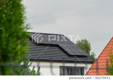 House roof with photovoltaic modules. Historic farm house with modern solar panels on roof and wall High quality photo 98279451