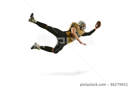 High flight. Man, american football player in motion, training, catching ball in jump over white studio background. Concept of sport, competition High flight. Man, american football player in motion, training, catching ball in jump over white studio background. Concept of sport, competition 98279452