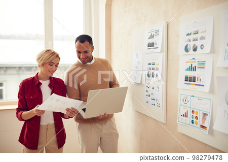 Smiling Colleagues Working Laptop Office. Happy Business Couple Using Computer Smiling Colleagues Working Laptop Office. Happy Business Couple Using Computer 98279478