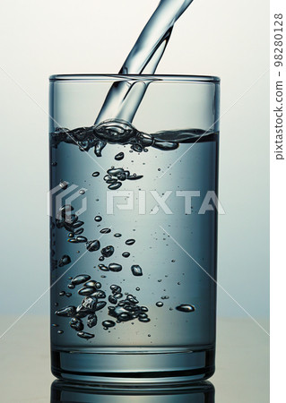 Water poured into the glass 98280128