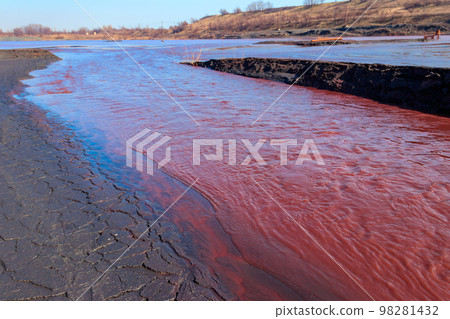 Technical settler of industrial water of mining industry in Kryvyi Rih, Ukraine. Red water polluted with iron ore waste. Discharge of process water in the sump after the iron ore beneficiation Technical settler of industrial water of mining industry in Kryvyi Rih, Ukraine. Red water polluted with iron ore waste. Discharge of process water in the sump after the iron ore beneficiation 98281432