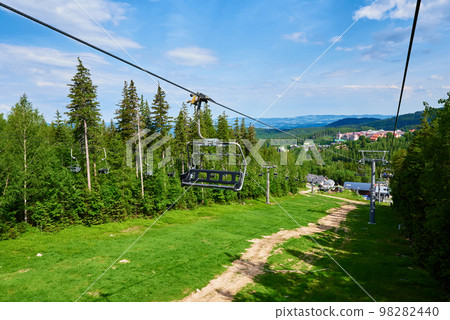 Ski lift in mountains. Karpacz resort in Poland with lift road. Mountain hiking and active vacation Ski lift in mountains. Karpacz resort in Poland with lift road. Mountain hiking and active vacation 98282440