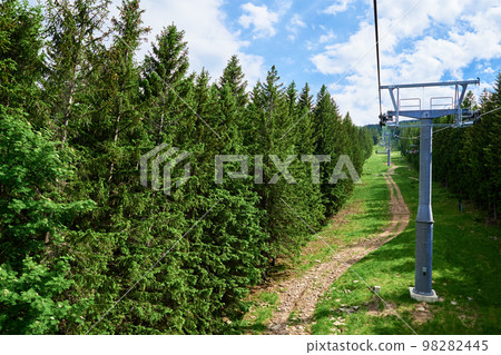 Ski lift in mountains. Karpacz resort in Poland with lift road. Mountain hiking and active vacation Ski lift in mountains. Karpacz resort in Poland with lift road. Mountain hiking and active vacation 98282445