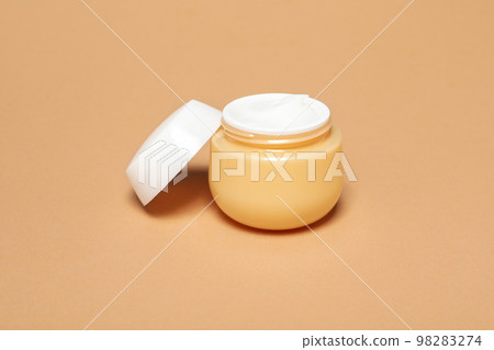 Jar with cream on beige background, close up Jar with cream on beige background, close up 98283274