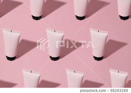Tube of cosmetic on pink background, space for text 98283289