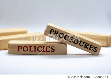Policies and procedures text on wooden blocks on white cover background. Policy and procedure concept. 98283631