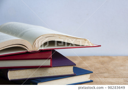 Books on wooden table with customizable space for text or ideas. Copy space and education concept. Books on wooden table with customizable space for text or ideas. Copy space and education concept. 98283649