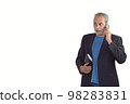 mature man in a suit with a calendar talking on the mobile on a white background 98283831
