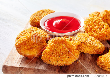 Chicken nuggets with ketchup close-up on a wooden board 98284004