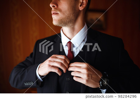 Luxury groom in suit. Businessman. Morning Groom Fees. The beginning of the wedding day. Men's fashion. Luxury groom in suit. Businessman. Morning Groom Fees. The beginning of the wedding day. Men's fashion. 98284296
