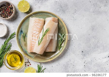 Raw cod loin fillet steak with aromatic herbs, spices, oil 98286177