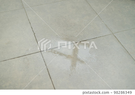 Water drips onto the tiled floor. Water drips onto the tiled floor. 98286349