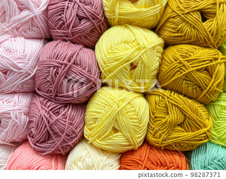 Multi colored balls of yarn for knitting. Woolen threads for needlework. Texture 98287371