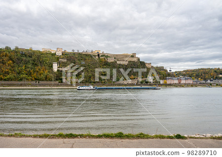German corner, Koblenz were Rhein and Mosel meet. A river barge in the foreground with the fortress Ehrenbreitstein in the background German corner, Koblenz were Rhein and Mosel meet. A river barge in the foreground with the fortress Ehrenbreitstein in the background 98289710