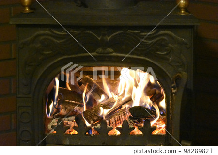 Burning a wood stove in a log house villa 98289821