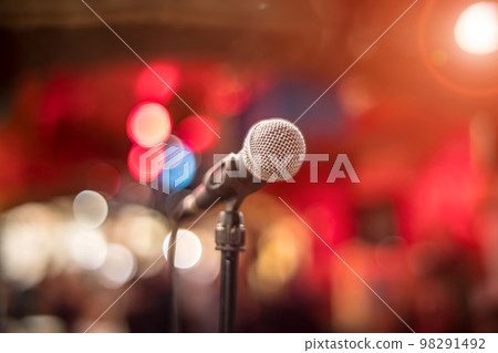 Microphone on stage against a background of auditorium. Microphone on stage against a background of auditorium. 98291492