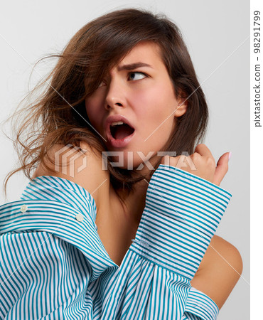 Closeup beauty fashion portrait of young sensual beautiful woman wearing male shirt posing on gray background. Female natural beauty, art, emotions concept Closeup beauty fashion portrait of young sensual beautiful woman wearing male shirt posing on gray background. Female natural beauty, art, emotions concept 98291799