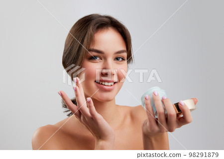 Portrait of beautiful happy young woman with smooth clear skin isolated over light studio background. Concept of natural beauty, skincare, cosmetology, health Portrait of beautiful happy young woman with smooth clear skin isolated over light studio background. Concept of natural beauty, skincare, cosmetology, health 98291879