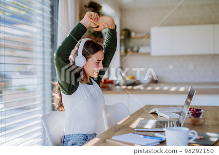 Young woman having video call in her apartment. 98292150