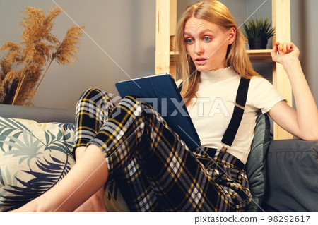 Woman at night home surfing on internet with digital tablet. Stay at Home. 98292617