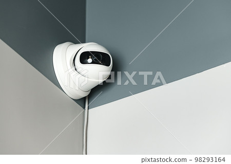 CCTV camera on gray wall close up 98293164