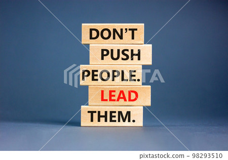 Push or lead people symbol. Concept words Do not push people lead them on wooden blocks. Beautiful grey table grey background. Business Push or lead people concept. Copy space. 98293510
