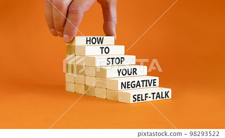 Stop negative self-talk symbol. Concept words Stop to flip your negative self-talk typed on blocks. Psychologist hand. Beautiful orange background. Psychological negative self-talk concept. Copy space Stop negative self-talk symbol. Concept words Stop to flip your negative self-talk typed on blocks. Psychologist hand. Beautiful orange background. Psychological negative self-talk concept. Copy space 98293522