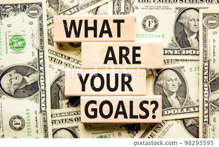 What are your goals symbol. Concept words What are your goals on wooden blocks. Beautiful background from dollar bills. Business, psychological what are your goals concept. Copy space. 98293595