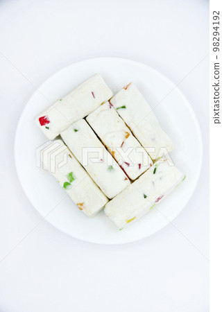 Pieces of juicy marshmallow on a white plate. Sweet oriental snack. Sweets for tea. Pieces of juicy marshmallow on a white plate. Sweet oriental snack. Sweets for tea. 98294192