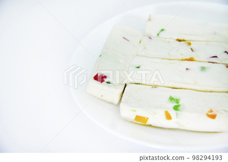 Pieces of juicy marshmallow on a white plate. Sweet oriental snack. Sweets for tea. Pieces of juicy marshmallow on a white plate. Sweet oriental snack. Sweets for tea. 98294193