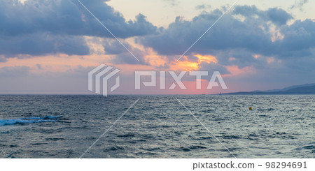 Mediterranean Sea is under cloudy sky on a sunset. Propriano, Corsica 98294691