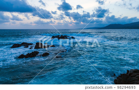 Dramatic coastal landscape with waves and rocks in the evening Dramatic coastal landscape with waves and rocks in the evening 98294693
