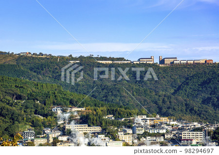 Kannawa Onsen's steam and a school building on a hill Kannawa Onsen's steam and a school building on a hill 98294697