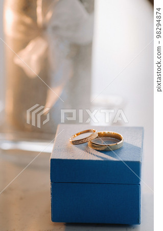 Designer wedding rings lying on the surface. Two wedding rings Designer wedding rings lying on the surface. Two wedding rings 98294874