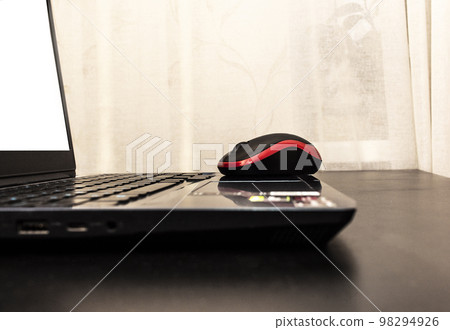 Black computer keyboard and mouse on a table. Work at home concept Black computer keyboard and mouse on a table. Work at home concept 98294926
