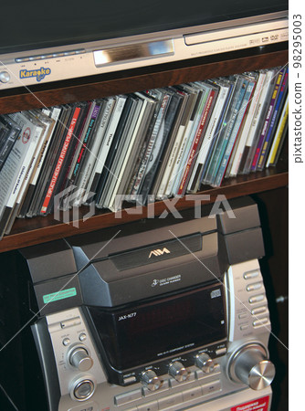 Old music center with cassettes and CDs from 90s. Compact disks and audio tapes 98295003