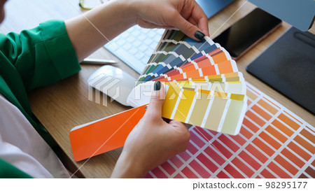 Designer choosing colors for his future project in art studio. 98295177