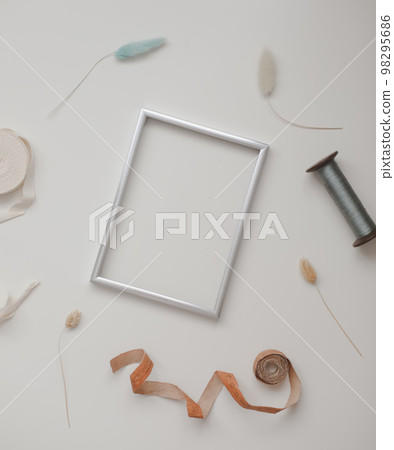 minimal mockup with blank frame with sewing thread and sewing items on white background, flatlay, top view, copy space minimal mockup with blank frame with sewing thread and sewing items on white background, flatlay, top view, copy space 98295686