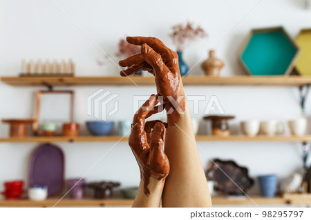 An expert potter, in his laboratory. The artisan creates works of art with his hands. Concept of 98295797