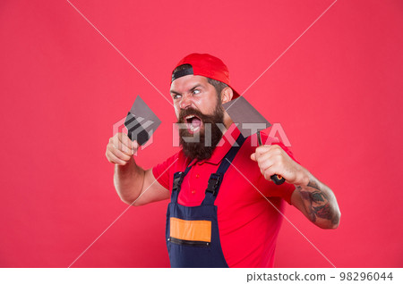 Successful renovation. Bearded man worker with plastering tools. Plasterer hipster builder in cap red background. Interior designer. Professional plasterer. Skillful plasterer. Repair success 98296044