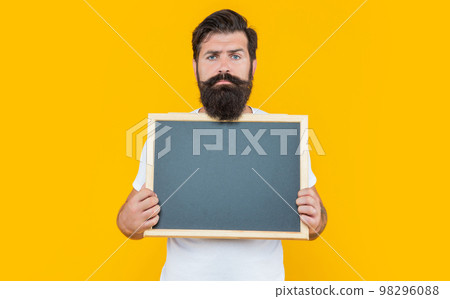 serious bearded man advertising on blackboard with copy space. bearded man advertising 98296088