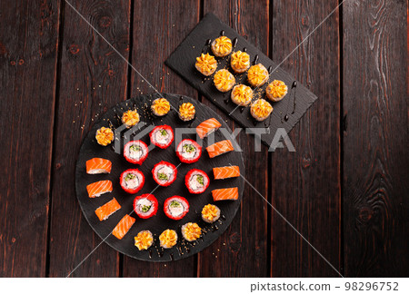 Rolls set with fish shrimp and caviar sushi with chopsticks - asian food and japanese cuisine concept top view 98296752