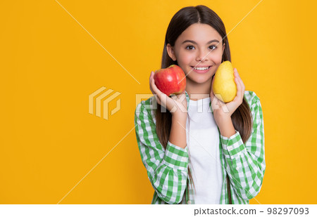 happy kid with apple and pear fruit on yellow background 98297093