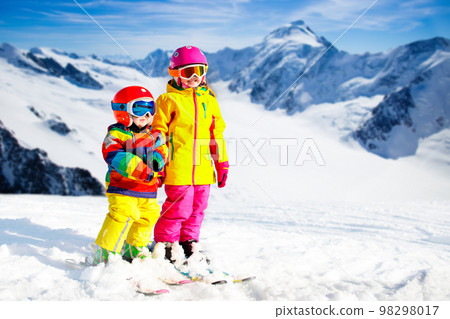 Kids winter snow sport. Children ski. Family skiing. 98298017