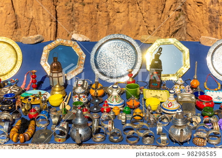 Multicolored Moroccan craft souvenirs at the market. Teapots and plates , decorations, tagines,, trinkets 98298585