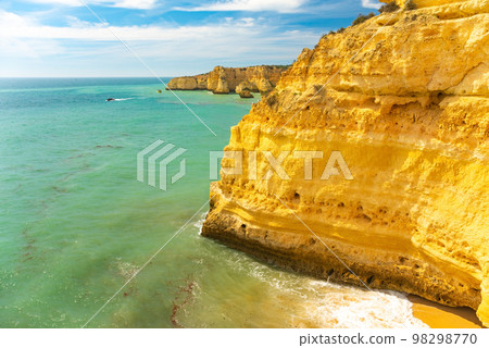 Natural caves and beach, Algarve Portugal. Rock cliff arches of Seven Hanging Valleys and turquoise sea water on coast of Portugal in Algarve region 98298770