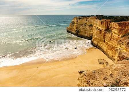 Natural caves and beach, Algarve Portugal. Rock cliff arches of Seven Hanging Valleys and turquoise sea water on coast of Portugal in Algarve region 98298772